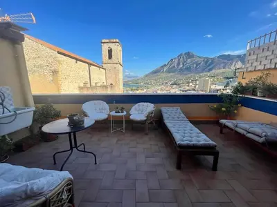 a balcony with a couch and chairs and a table at Bella Vista Sant Orsula 2 bedroom View Terrace Historic Center Spacious Apartment in Termini Imerese