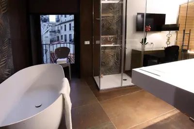 a bathroom with a white sink and a desk at Palazzo Cartari in Palermo