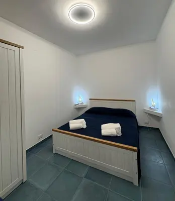 a bedroom with a bed with two towels on it at Casa Vacanze Marinella Beach in San Vito lo Capo