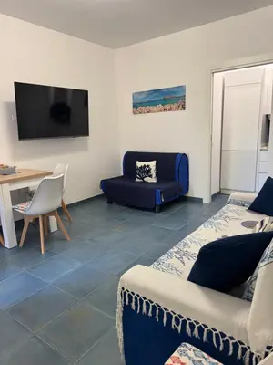 a living room with a couch and a table at Casa Vacanze Marinella Beach in San Vito lo Capo
