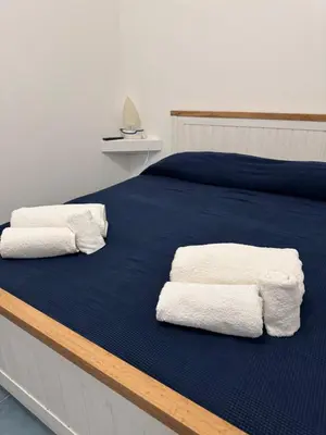 a bed with two white towels on top of it at Casa Vacanze Marinella Beach in San Vito lo Capo