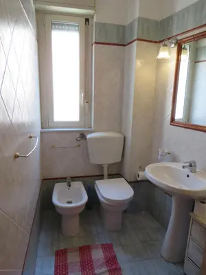 a bathroom with a toilet and a sink at Awesome terrace and apartment in the city centre in Palermo