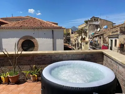 a hot tub on top of a building at Awesome terrace and apartment in the city centre in Palermo