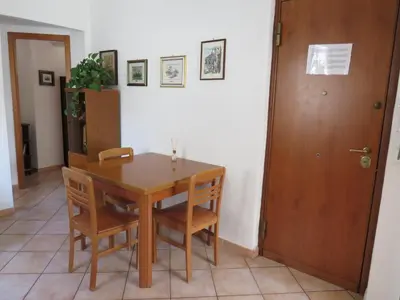 a dining room with a table and chairs and a door at Awesome terrace and apartment in the city centre in Palermo