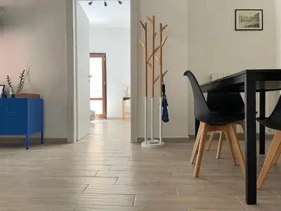 a living room with a table and a piano at Casa Giura in Palermo