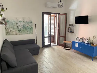 a living room with a couch and a blue cabinet at Casa Giura in Palermo