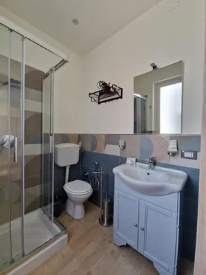 a bathroom with a toilet and a sink and a shower at Posidonia B&B in Terrasini