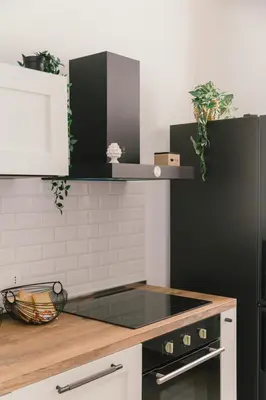 a kitchen with a black and white stove top oven at Ballaro' House in Palermo