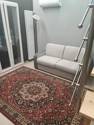 a living room with a couch and a rug at Casa da Giannina in Palermo