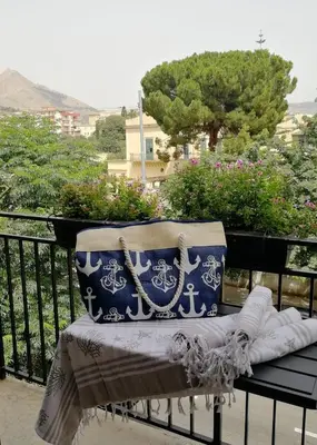 a bench with blue and white pillows on a balcony at Casa da Giannina in Palermo