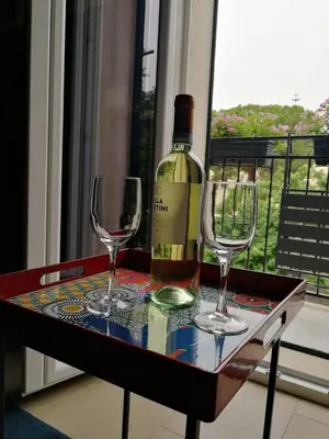 a bottle of wine and two wine glasses on a table at Casa da Giannina in Palermo
