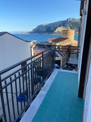 a balcony with a view of the ocean from aominium at Casa Peppino in Palermo