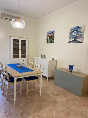 a kitchen with a table and chairs in a room at Casa Peppino in Palermo