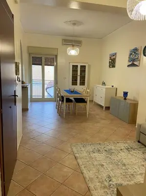 a kitchen and living room with a table and chairs at Casa Peppino in Palermo