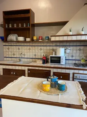 a kitchen with a table with two cups on it at Casa Peppino in Palermo