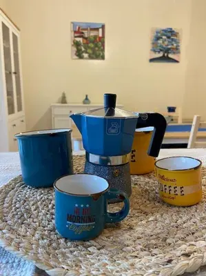 a table with a coffee maker and two cups at Casa Peppino in Palermo