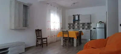 a kitchen with a table and chairs in a room at Casa vacanze Il Girasole in Bagheria