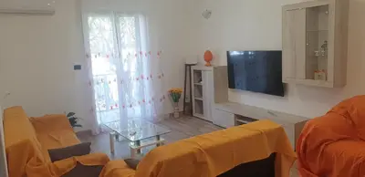a living room with a couch and a tv at Casa vacanze Il Girasole in Bagheria
