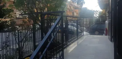 a blue iron gate with a sidewalk next to a street at Casa vacanze Il Girasole in Bagheria