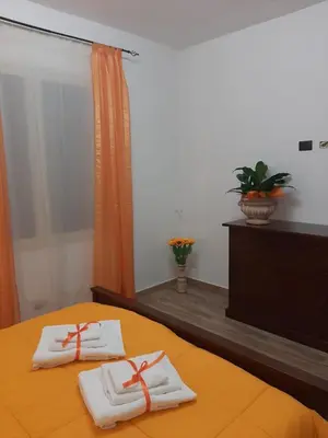 a bed with two white towels on top of it at Casa vacanze Il Girasole in Bagheria