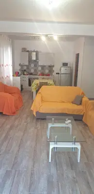 a room with two beds and a table in it at Casa vacanze Il Girasole in Bagheria