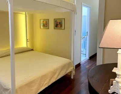 a bedroom with a bed and a table with a lamp at La casa del Maestro in Palermo