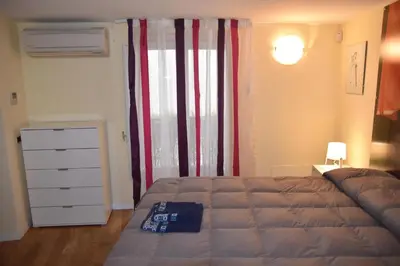 a bedroom with a bed and a dresser and a window at Prince Moncada in Palermo