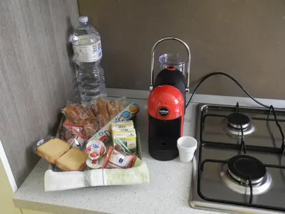 a counter top with a bottle of water and some food at Prince Moncada in Palermo
