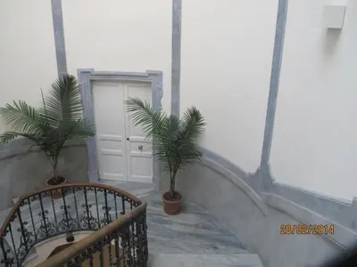 a staircase with two palm trees and a white door at Prince Moncada in Palermo