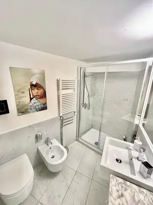a bathroom with a shower and a toilet and a sink at Prince Moncada in Palermo