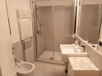 a bathroom with a shower and a sink and a toilet at Prince Moncada in Palermo