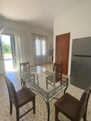 a glass table and chairs in a living room at Il Rifugio della Grotta S.Ninfa in Santa Ninfa