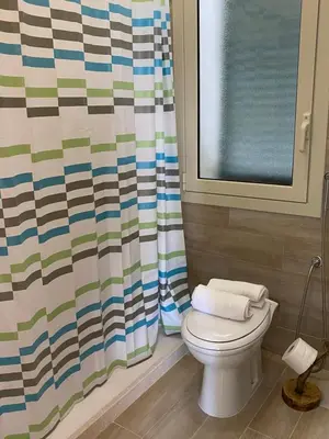 a bathroom with a toilet and a shower curtain at Il Rifugio della Grotta S.Ninfa in Santa Ninfa