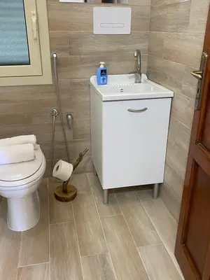 a bathroom with a toilet and a sink at Il Rifugio della Grotta S.Ninfa in Santa Ninfa