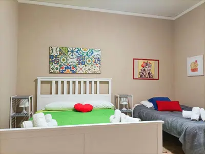 a bedroom with a bed with a red heart on it at Villemar in Isola delle Femmine