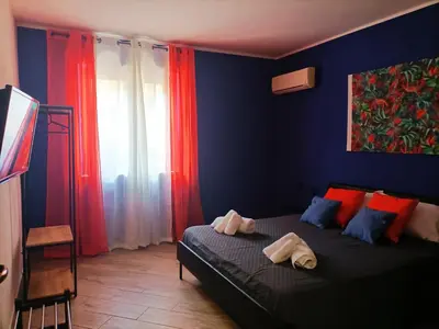a bedroom with a bed with two towels on it at Villemar in Isola delle Femmine