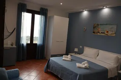 a bedroom with a bed with two towels on it at Verdemare in Macari