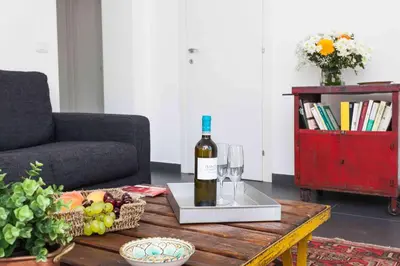 a bottle of wine on a table in a living room at Guascone Apartments in Palermo
