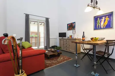 a living room with a red couch and a table at Guascone Apartments in Palermo