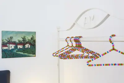 a baseball bat hanging on a wall next to a painting at Guascone Apartments in Palermo