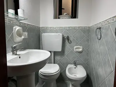 a bathroom with a toilet and a sink at DM house in Palermo