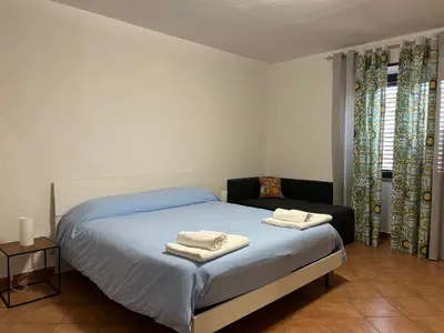 a bedroom with a bed with towels on it at DM house in Palermo