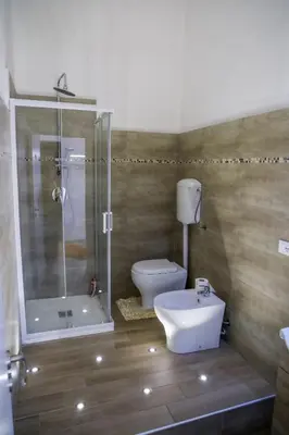 a bathroom with a shower and a toilet and a sink at L'Incanto centrale in Palermo
