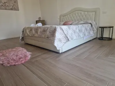 a bedroom with a bed and a wooden floor at L'Incanto centrale in Palermo