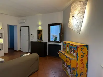 a living room with a couch and a window at Terrazza Rosa Bianca in Palermo