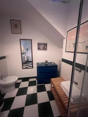 a bathroom with a black and white checkered floor at Terrazza Rosa Bianca in Palermo