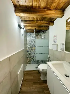 a bathroom with a toilet and a sink at Mafone Home in Palermo
