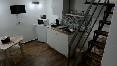 a small kitchen with a sink and a microwave at Mafone Home in Palermo