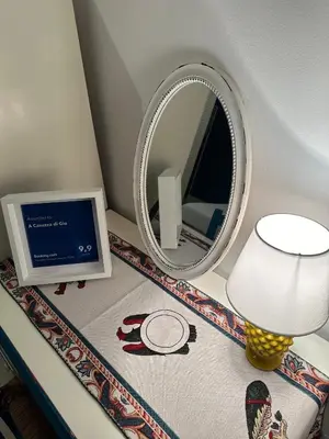 a room with a mirror and a lamp and a table with a lamp at A Casuzza di Gio in Palermo