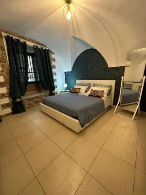 a bedroom with a large bed in a room at A Casuzza di Gio in Palermo